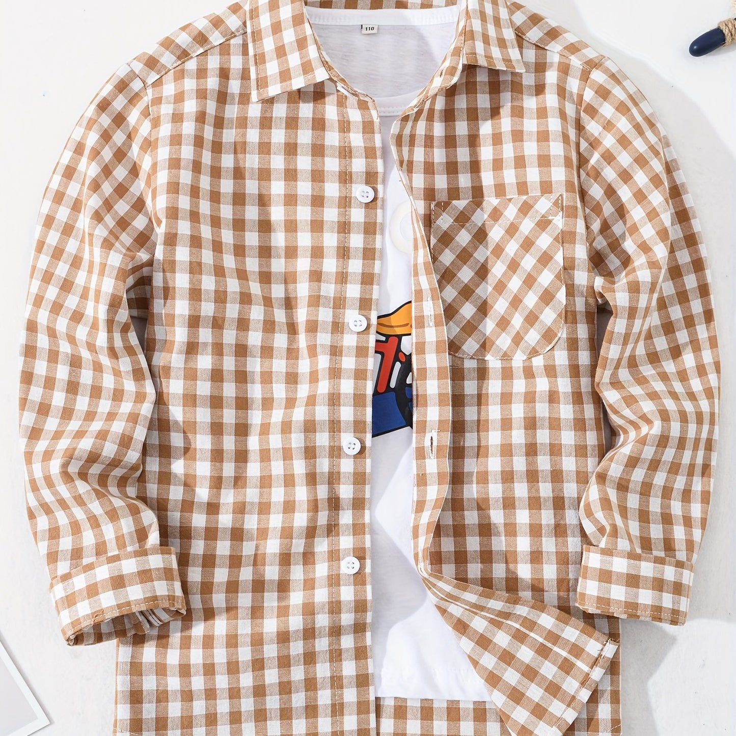 Children's preppy plaid long sleeve shirt made from 100% cotton woven fabric. Features a regular fit with lapel collar and button details. Non-stretch material suitable for boys and girls.