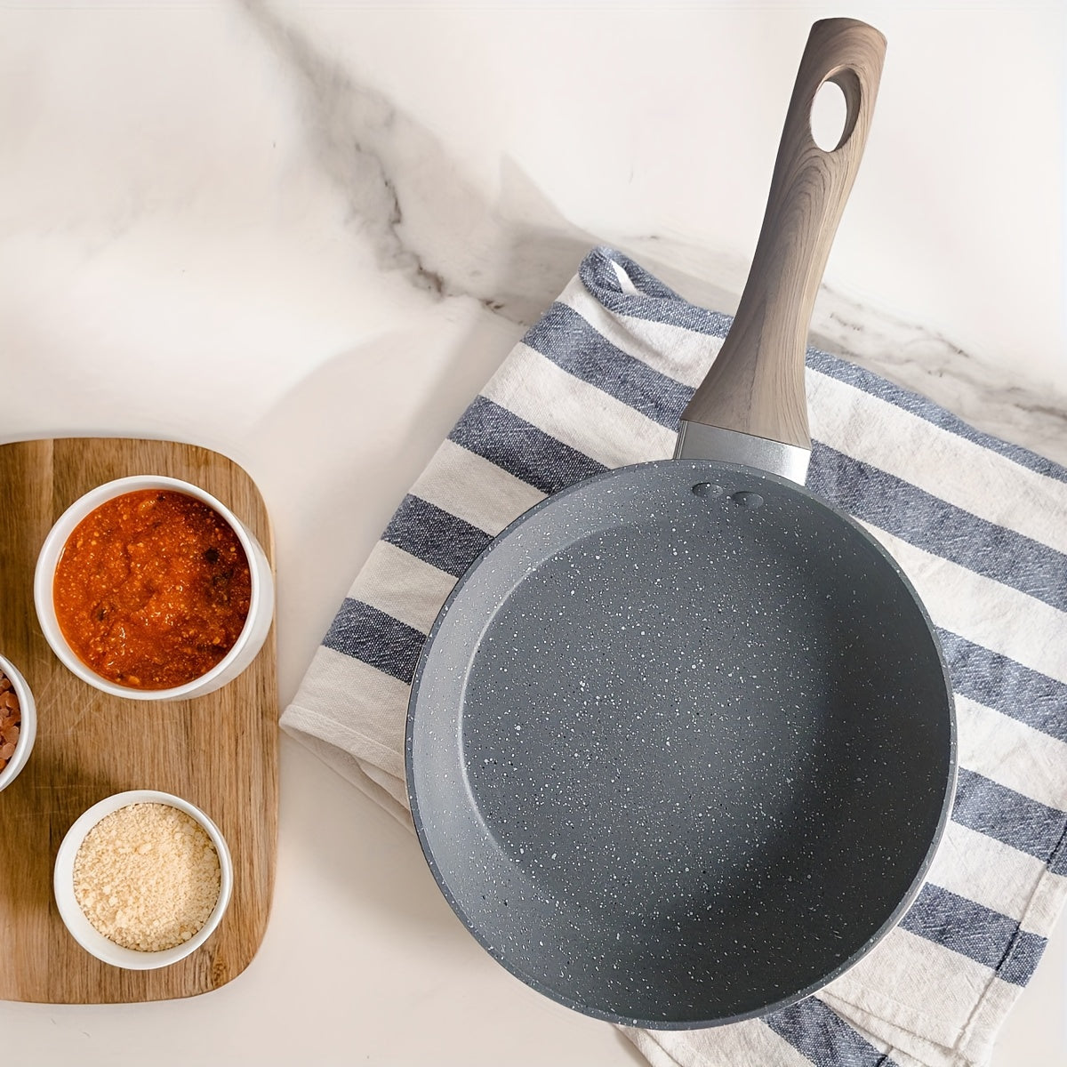 Non-stick aluminum frying pan designed for frying eggs and steaks on household induction cookers and gas stoves. Constructed with gray granite stone for durability.