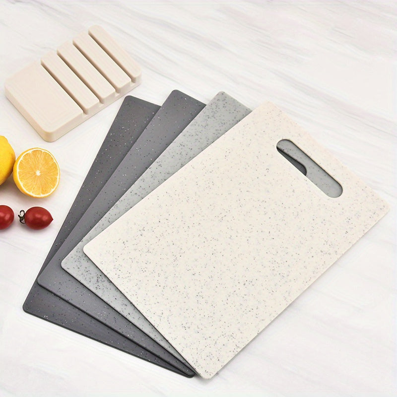 Set of 4 household kitchen cutting boards made of plastic. This multifunctional set includes a chopping board with an easy-grip handle, a cutting board mat, and is perfect for cutting fruits. Ideal for kitchen and dorm supplies.