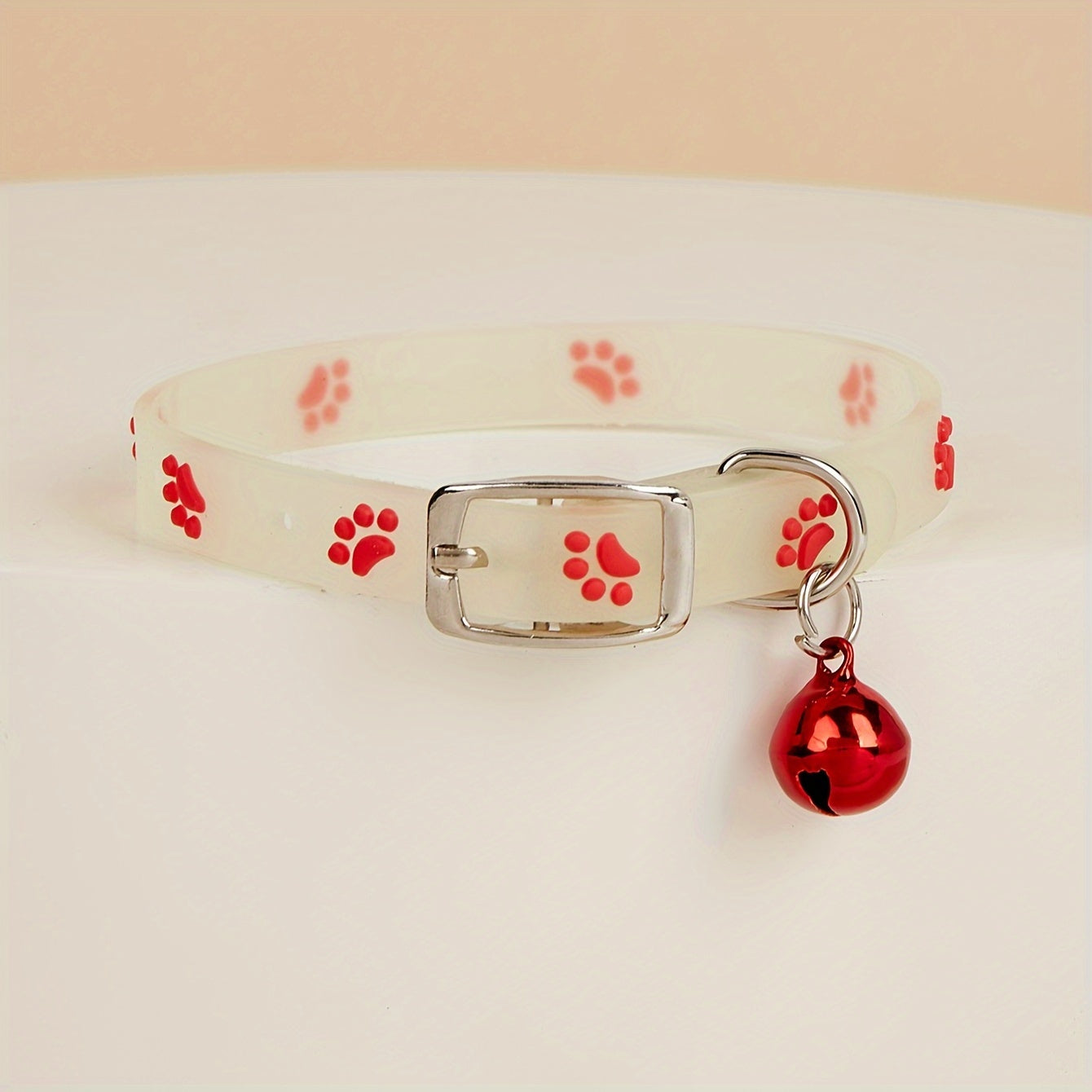 Adjustable glow-in-the-dark cat collar with colorful paw print for easy spotting at night.