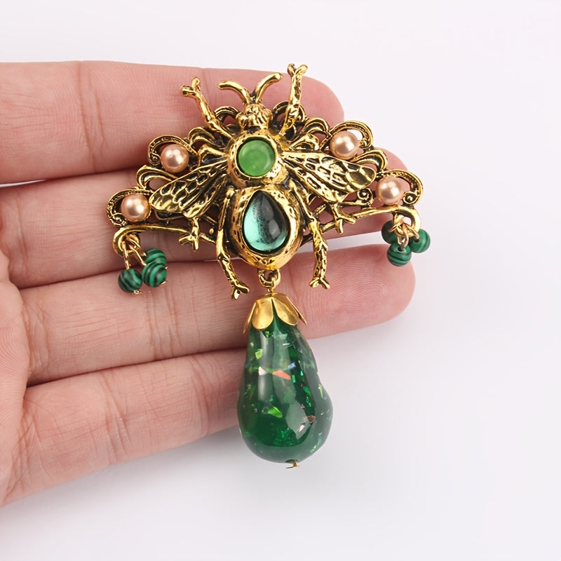 Bee brooch pin with vintage-inspired butterfly design, adorned with rhinestones and intricate green enamel accents, perfect for adding flair to coats and dresses.