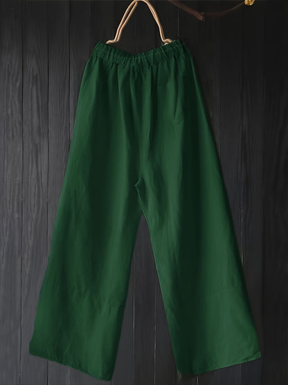 Stylish high-waisted plus-size cotton trousers with pockets, button details, solid color, and wide legs.