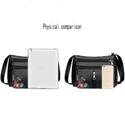 Men's fashion shoulder bag with large capacity, soft faux leather, floral embroidery, zipper closure, and casual messenger style.