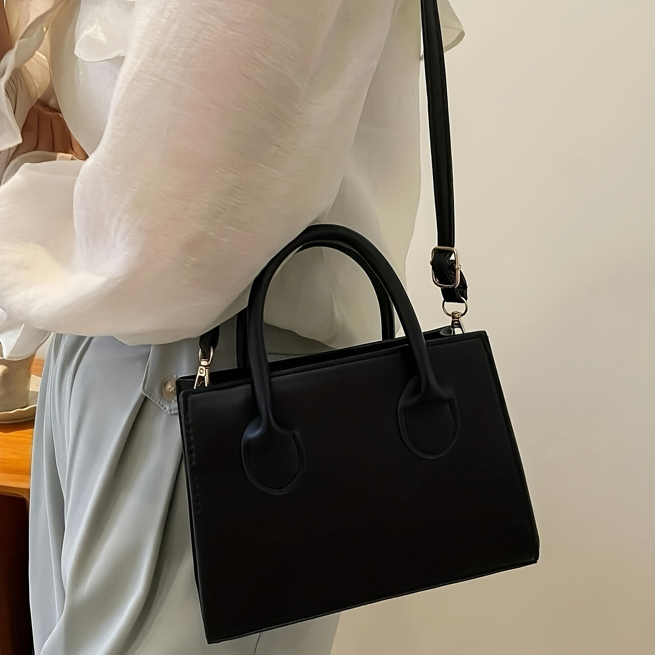 Stylish square handbag for women with mini crossbody and top handle design.