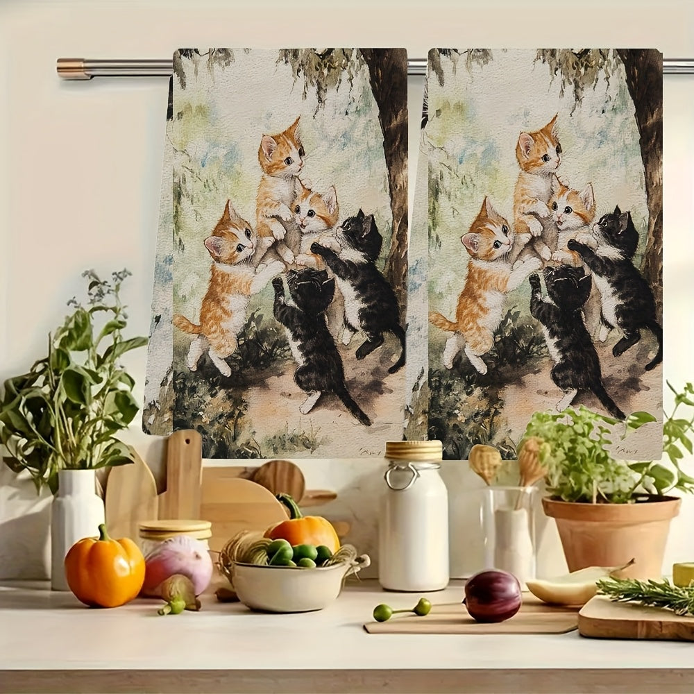 Two ultra plush kitchen towels featuring a playful kittens design. These highly absorbent towels are machine washable and measure 40.64x60.96 cm. Perfect for adding a touch of holiday charm to your kitchen decor and suitable for everyday use as dish