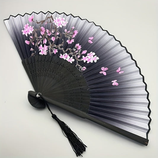 Vintage bamboo folding fan with cherry blossom design, black to purple gradient, tassel detail, traditional Hanfu dance accessory. Portable and decorative gift for women, ideal for graduation season.