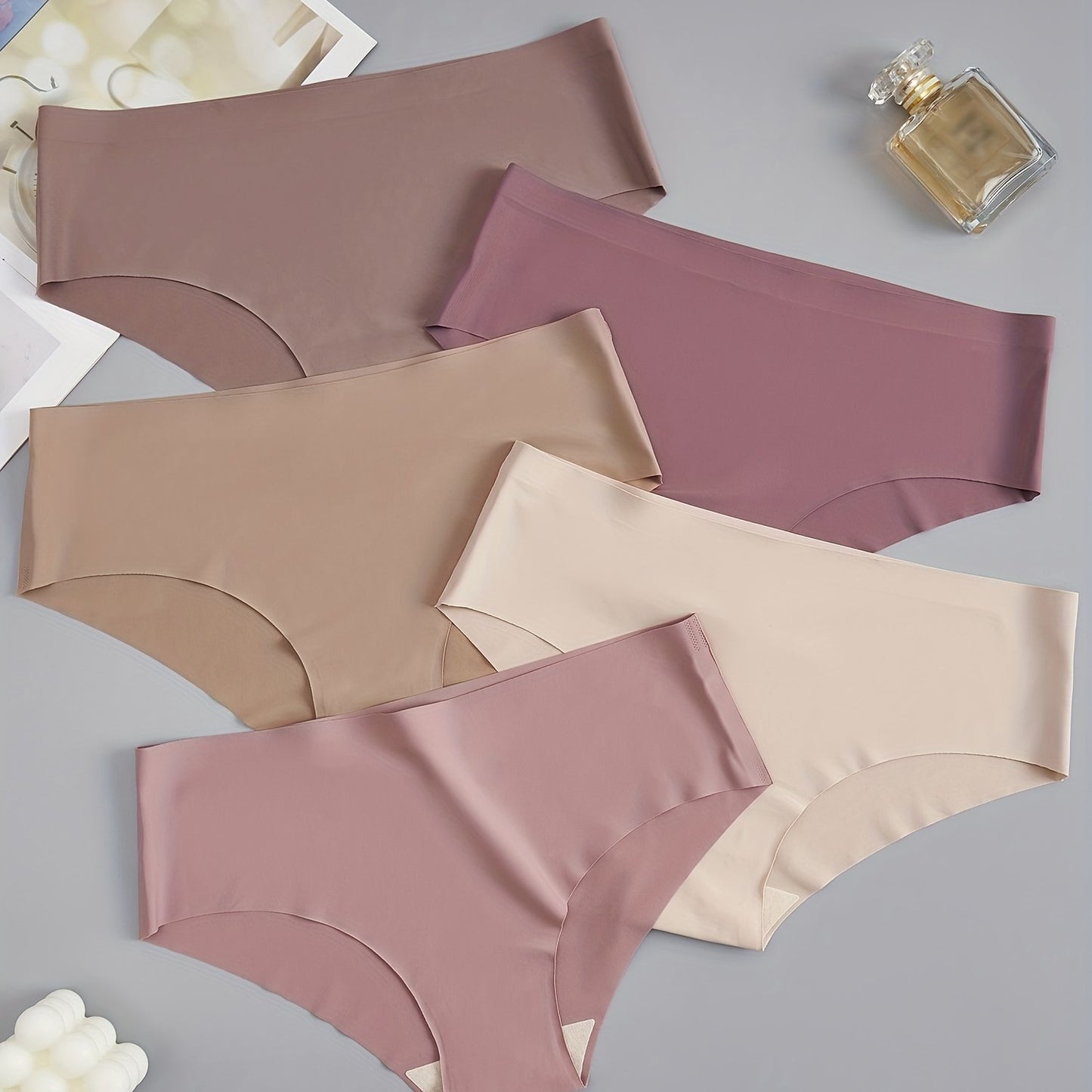 5 seamless women's briefs in assorted brown and purple shades, made from a soft and comfortable nylon blend. Low-rise with a stretch fit, non-see-through material. Comfortable lingerie with