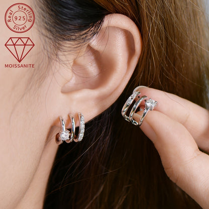 These stunning Moissanite earrings feature a total weight of 4.09g and are set with 4mm*2pcs, 1.6mm*14pcs, and 0.42ct*2pcs Moissanite stones. Crafted from 925 Sterling Silver, these Women's Fashion Half-Open Three-Ring Earrings are designed as a pair and