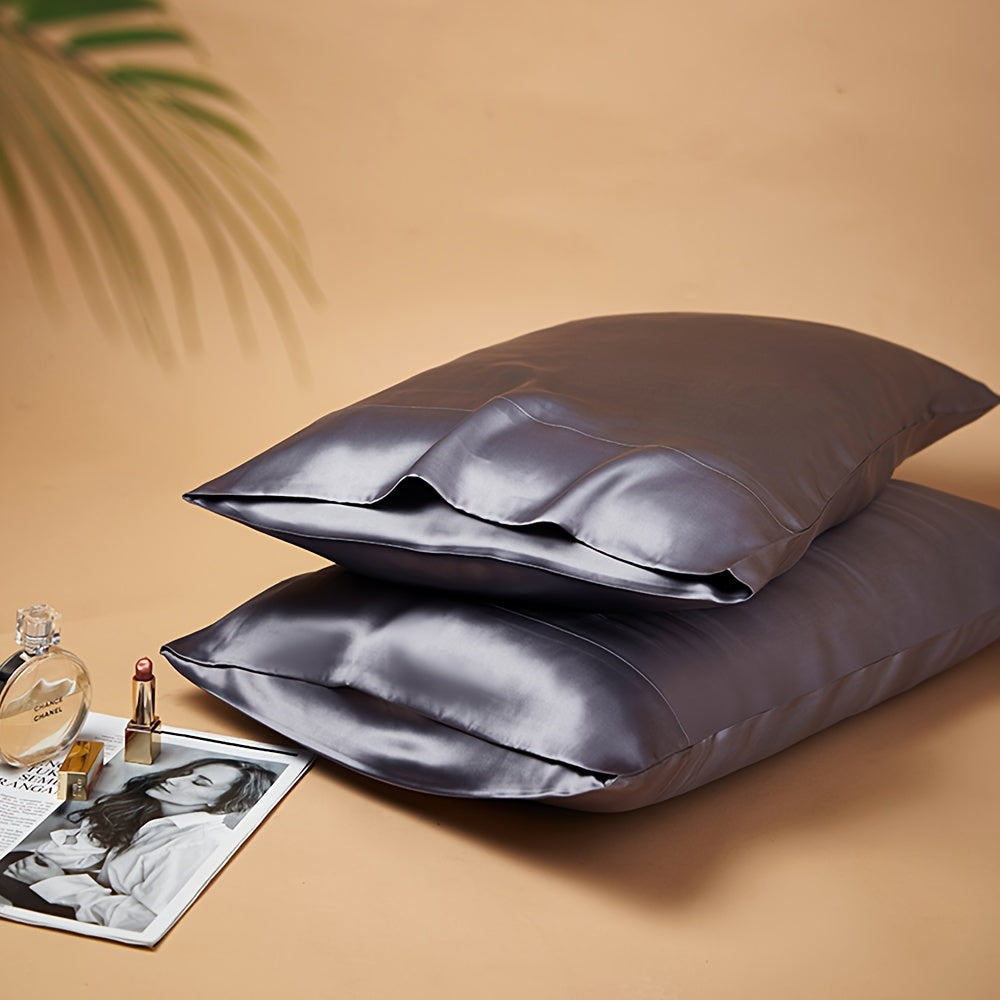 Two-pack of luxurious silky satin pillowcases, made from ultra soft smooth polyester with an envelope closure design. Available in solid colors, these machine washable pillow covers are lightweight at 80-85gsm, providing cooling comfort for hair and