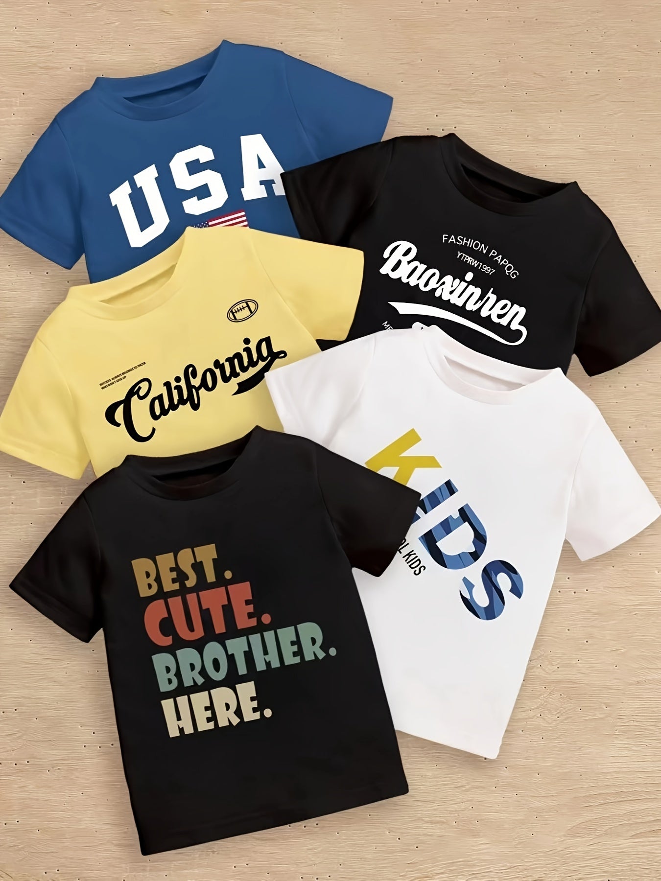 5-piece boy's summer casual tee with various prints: 'USA', calligraphy letter pattern, 'KIDS...', 'BEST CUTE...', and 'CALIFORNIA...'. Cool, comfy, and versatile gift option.