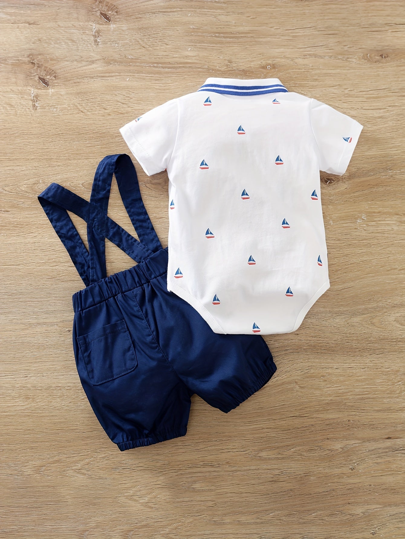 Newborn cotton romper with suspenders for outdoor wear.