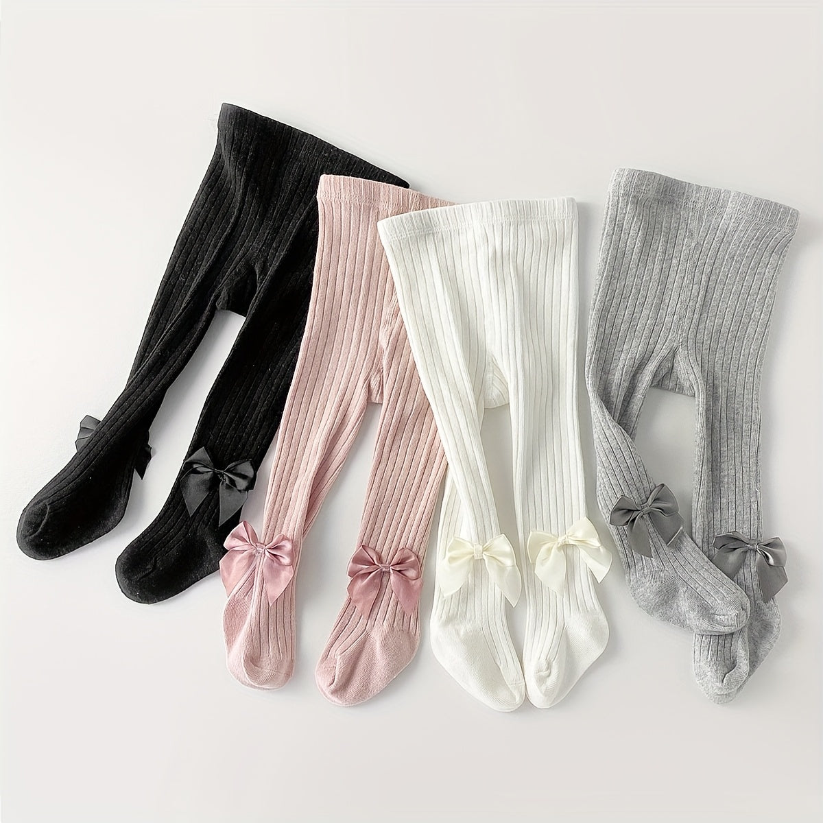 Adorable bow-knot girls' leggings socks in soft ribbed knit, perfect for dance and casual attire. Available in various colors.