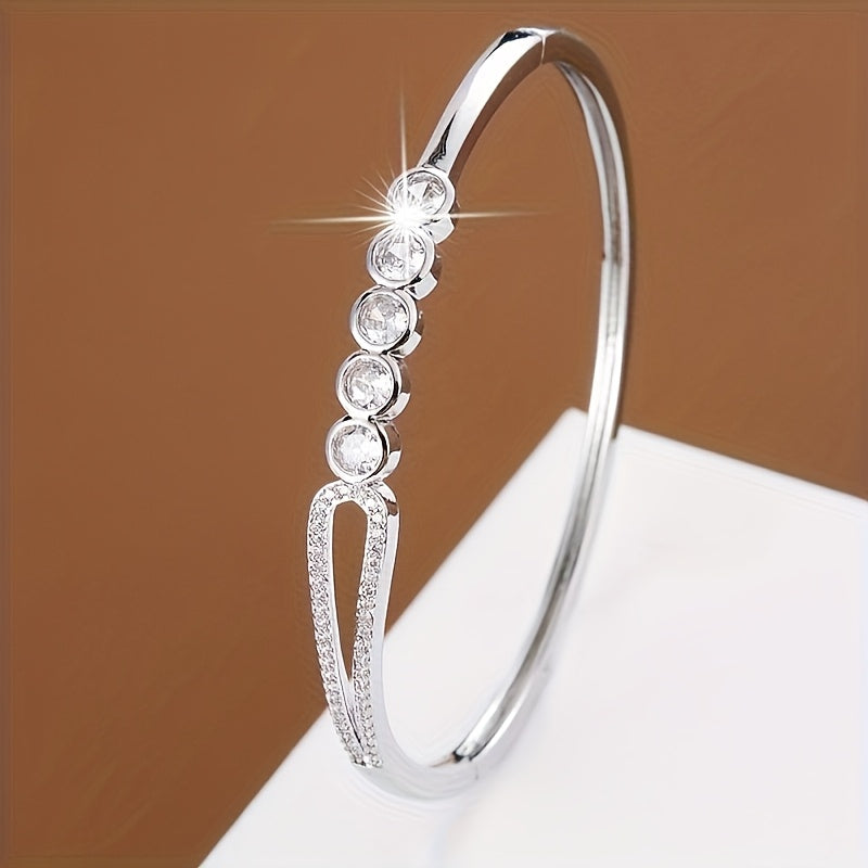 A bracelet for women featuring a circular bead ring clasp adorned with zirconia stones.