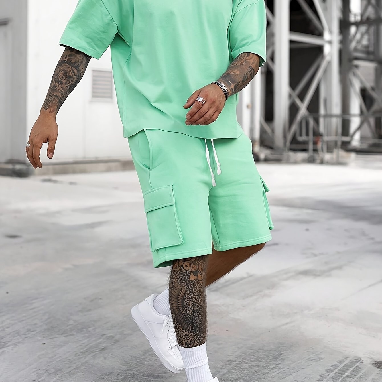 Men's casual sportswear set includes polyester t-shirt and drawstring shorts with pockets, ideal for summer and machine washable.