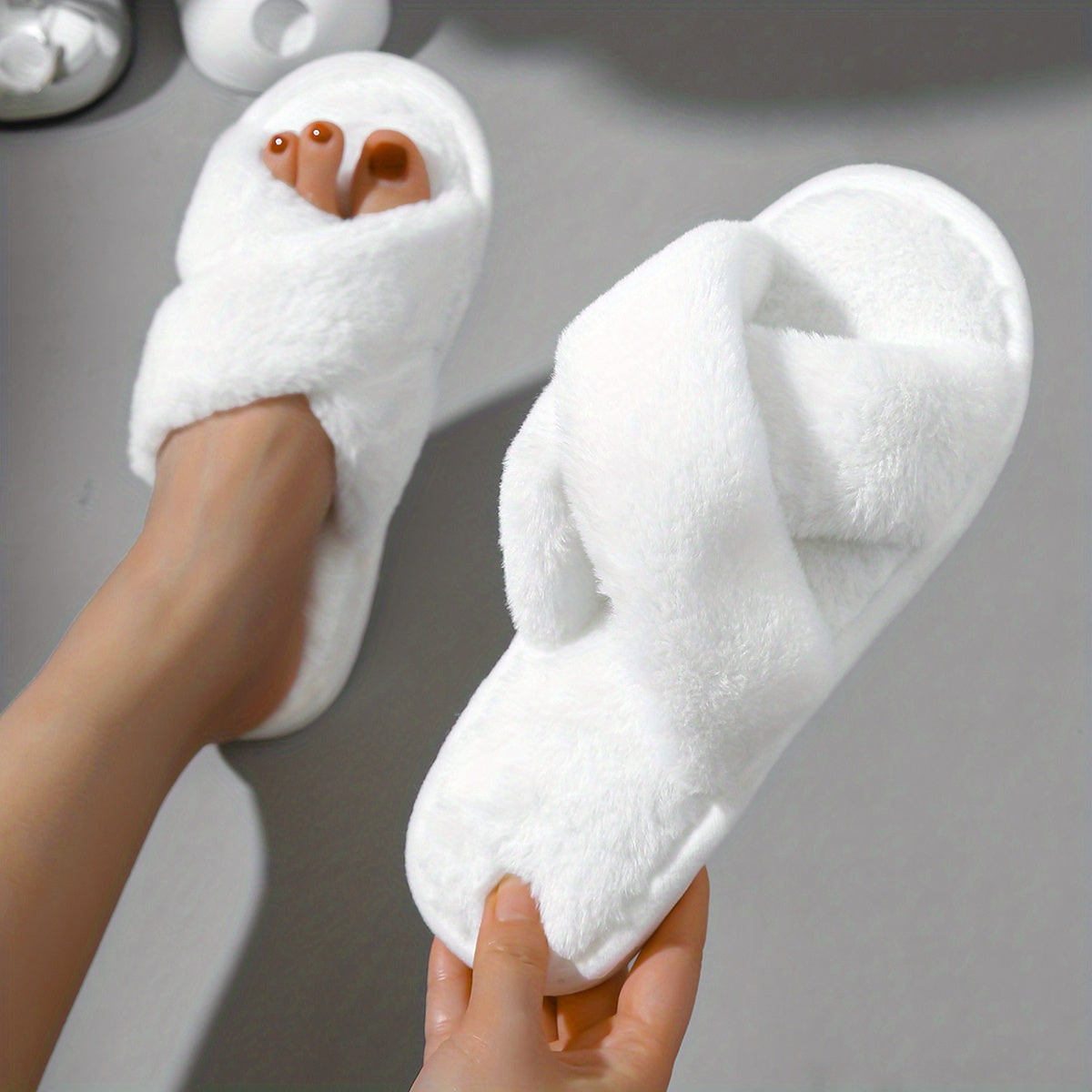 Plush cross-strap slippers for cozy indoor comfort.