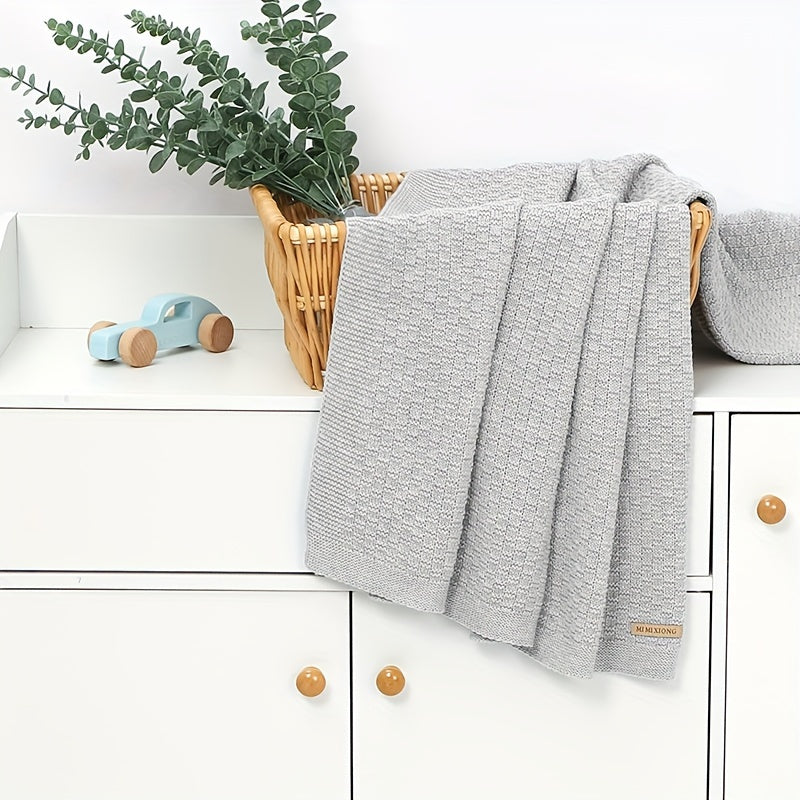 Dreamwrap is an ultra-soft knit blanket designed for youngsters. This solid color blanket is perfect for use in cribs and strollers. It is recommended to hand wash only. Available colors include gray, white, and pink.