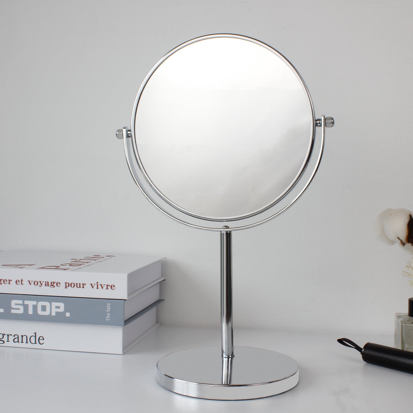 Double-sided magnifying makeup mirror with 10X/1X magnification. Rotate 360 degrees for use in desktop, bathroom, and office.