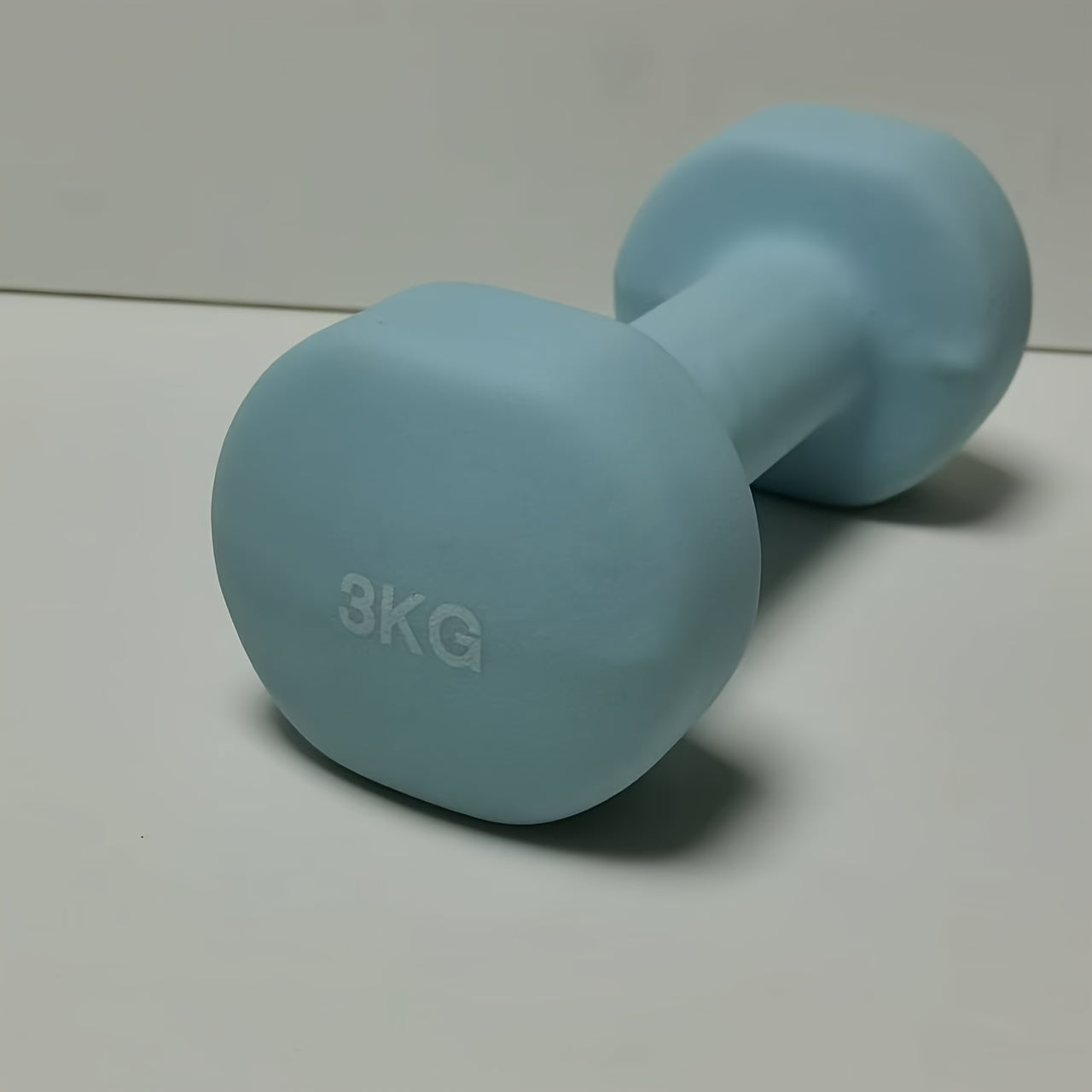 1pc 2kg dumbbell in pink/blue/black colors, made of solid cast iron for home gym. Durable and stylish fitness accessory for both men and women.