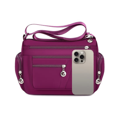 Women's versatile crossbody bag with adjustable strap, multiple compartments, zipper closure, and polyester lining for shopping, office, and travel, available in multiple colors.