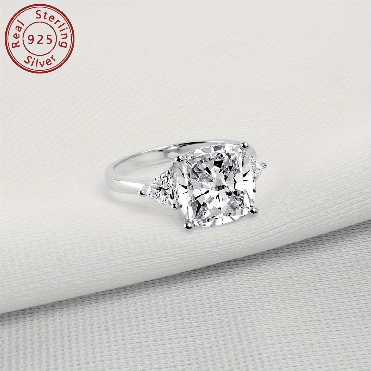 This stunning engagement ring features an elegant design with sparkling 3-stone synthetic cubic zirconia in square and triangle shapes. Made from 925 sterling silver with a high-polished finish, this ring is perfect for weddings and anniversaries. It