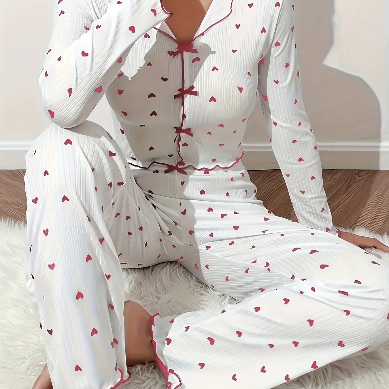 Heart print lounge set with frill trim and bow detail, featuring a V-neck crop top and pants for a comfortable and relaxed fit in the fall.