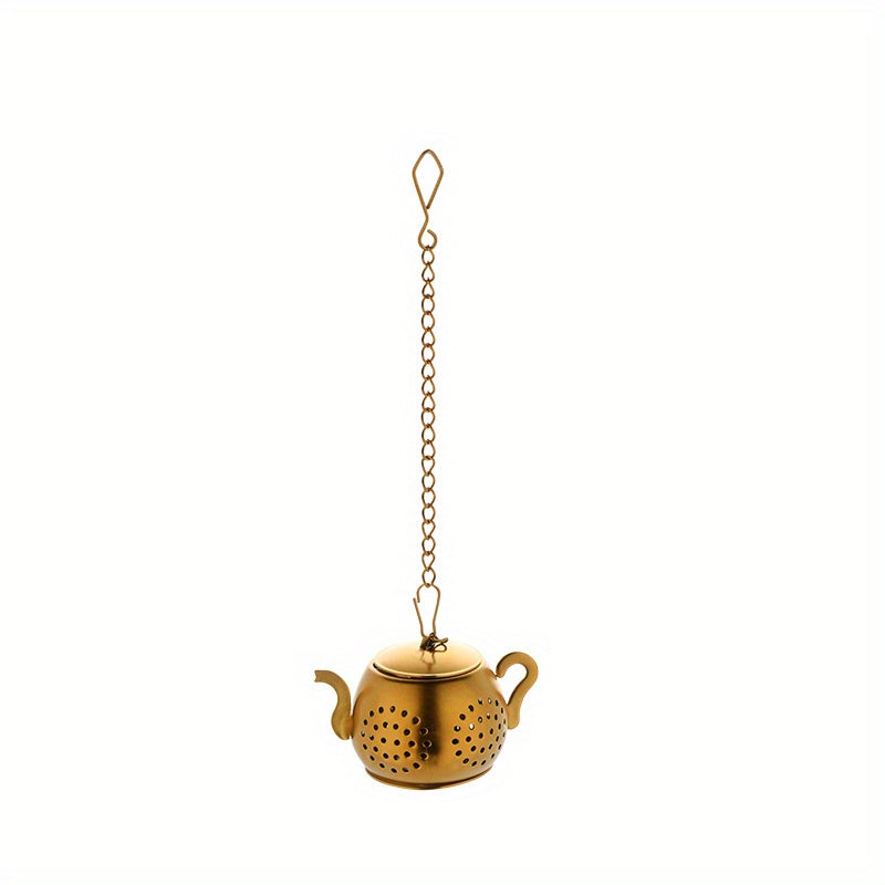 Golden rose stainless steel teapot-shaped tea strainer with uniform filter holes and hanging chain for cups.