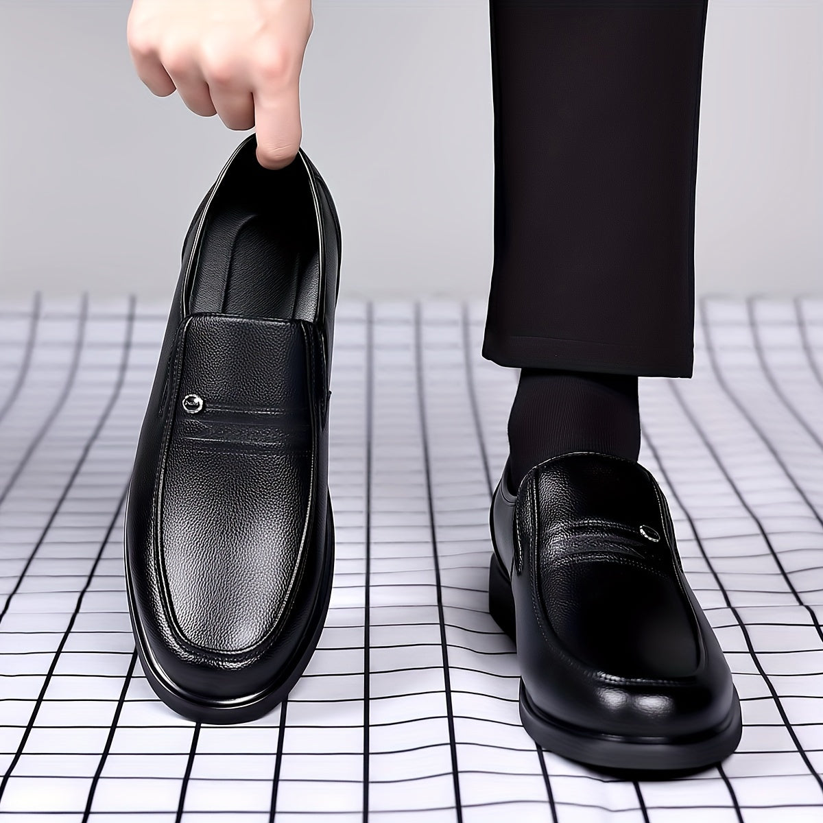 Black slip-on loafers for men featuring a rubber sole, round toe, and embossed logo - perfect for casual attire.