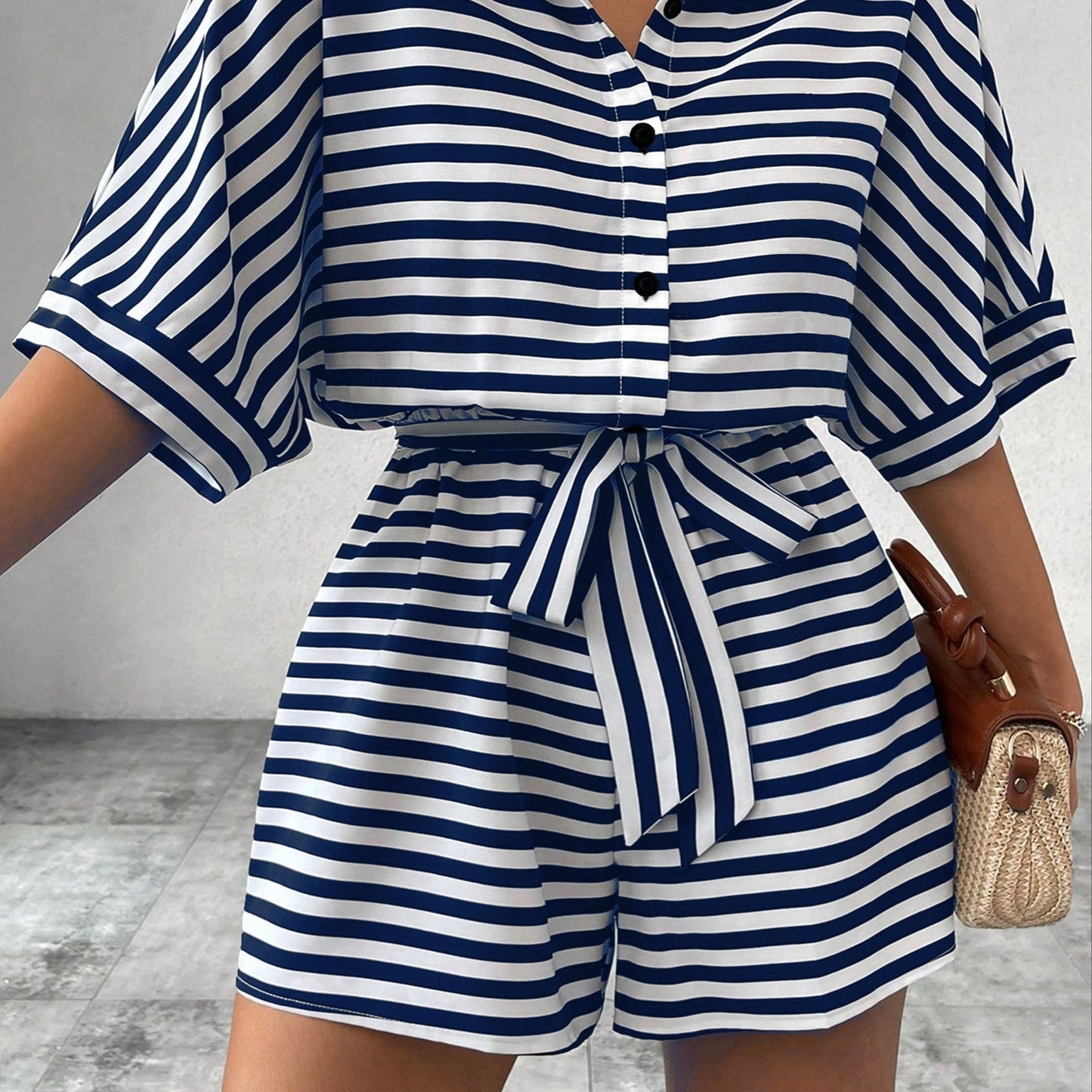 Button front romper jumpsuit with stripes, belt, short sleeves for spring and summer.