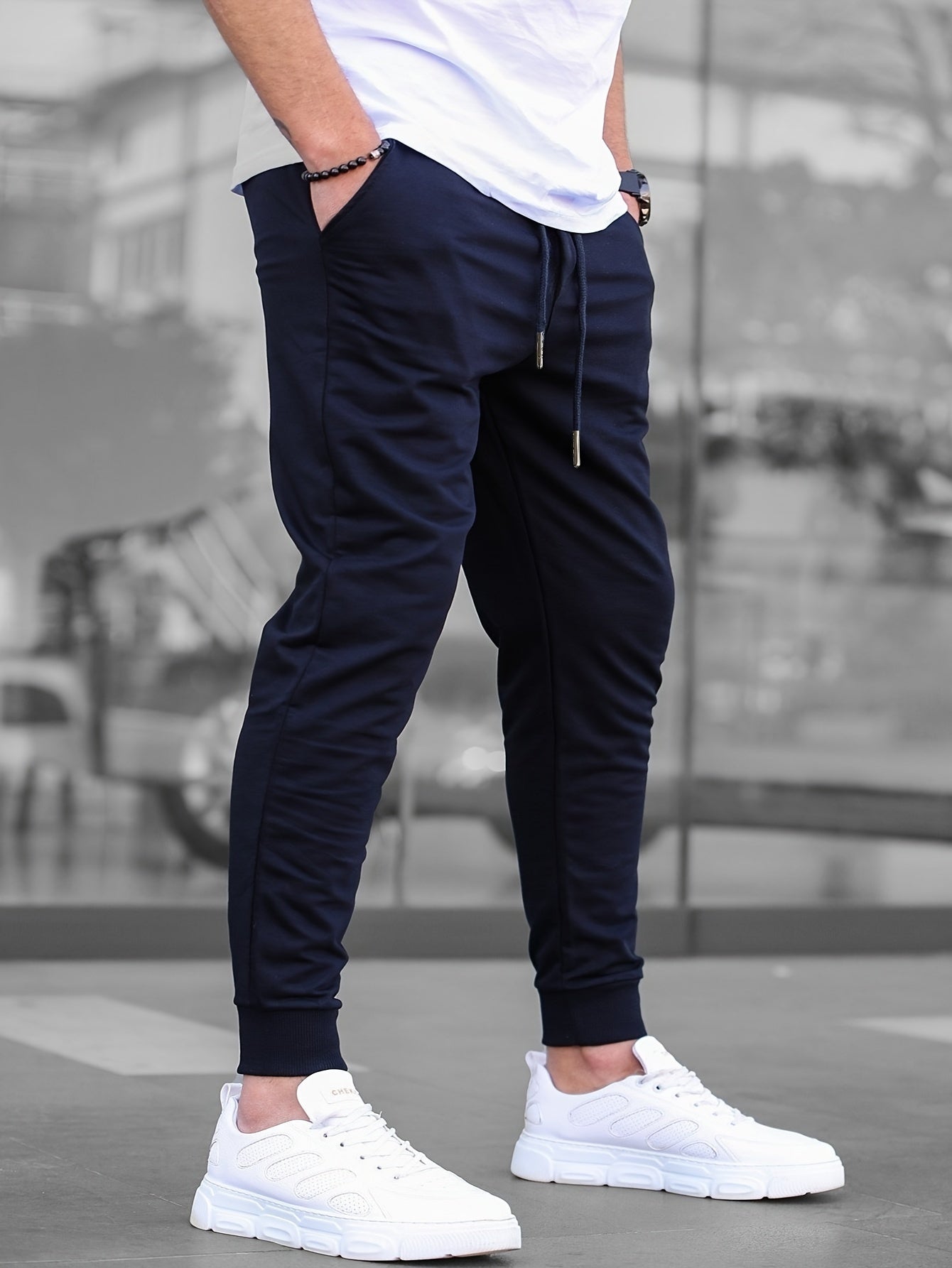 Solid color jogger pants for men with drawstrings, lightweight and breathable for running and fitness.