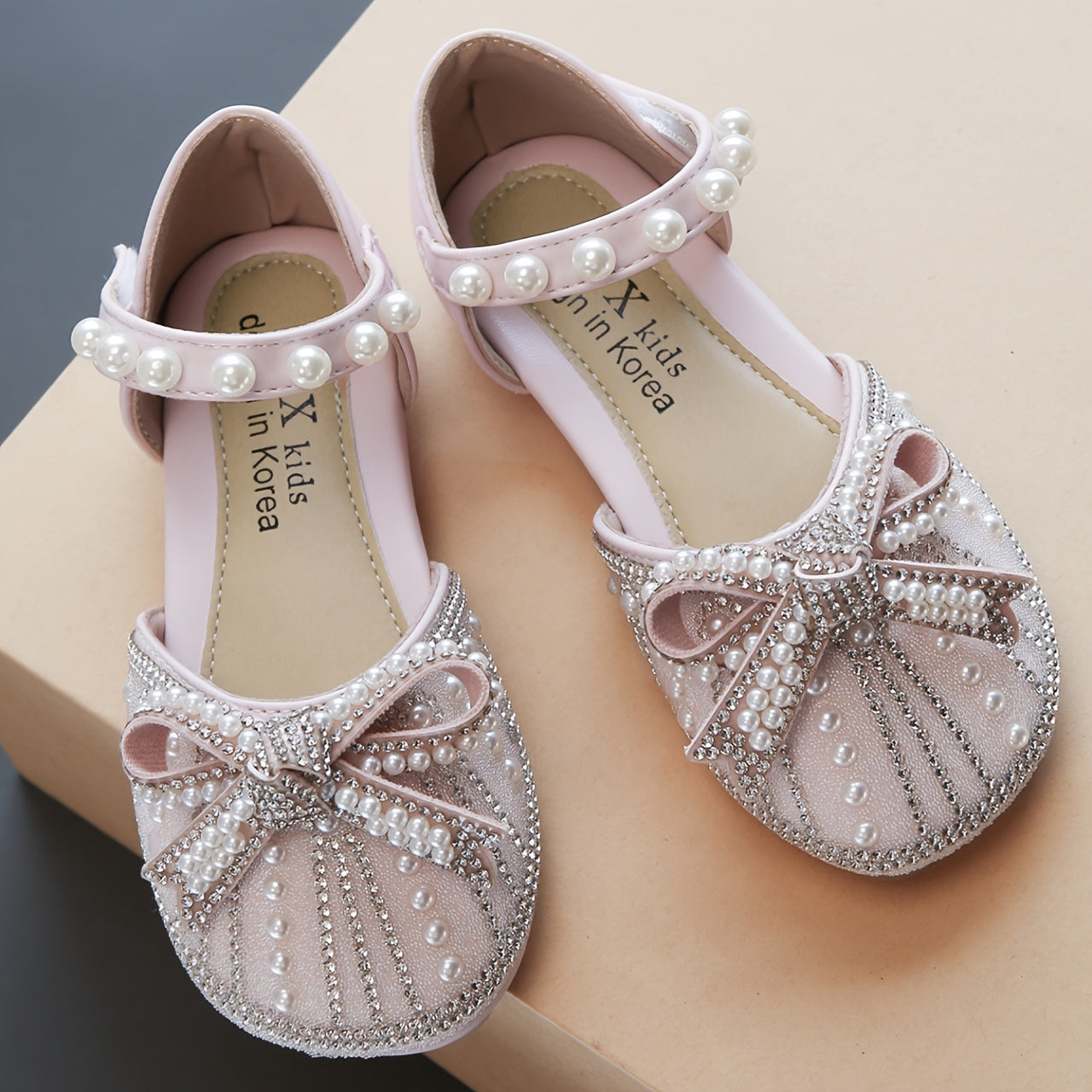 Sparkly bowknot flats with adjustable strap, durable TPR sole, comfortable for daily wear for girls aged 14 and under.