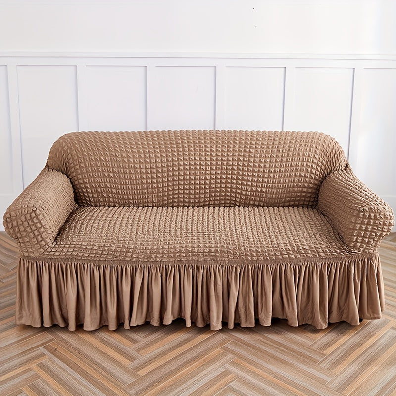 Seersucker skirt sofa cover protects couch from cat scratches in bedroom, office, or living room.