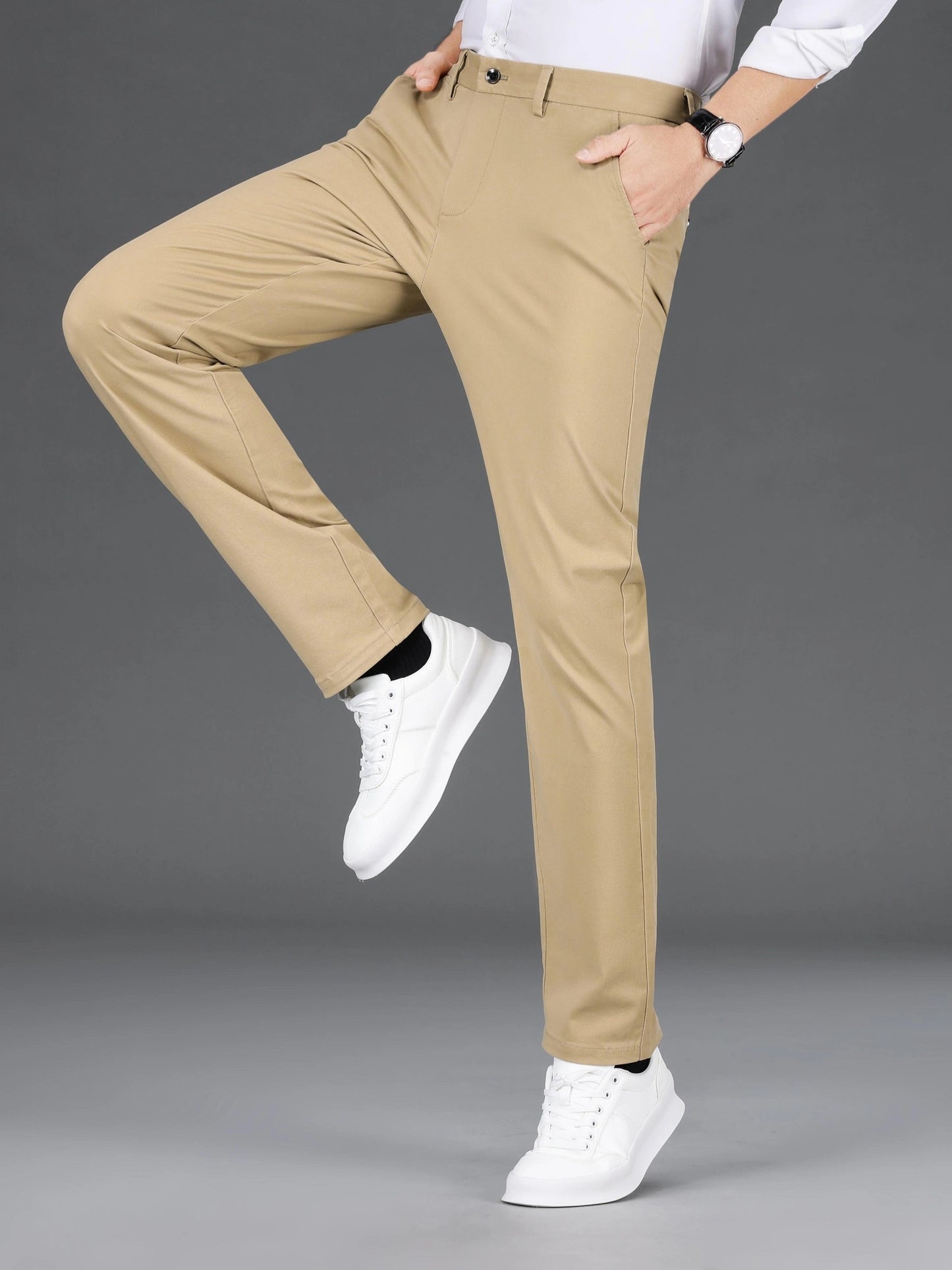 Men's slim-fit cotton blend trousers in solid color, suitable for business casual wear throughout the year. Features micro-elastic fabric, pockets, and regular length.