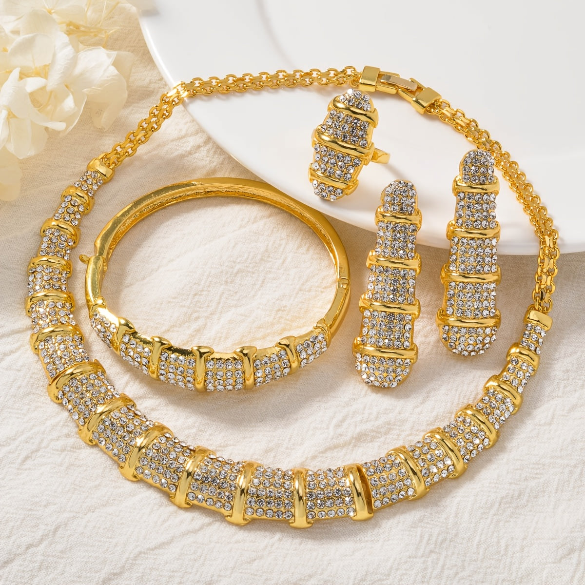 An elegant jewelry set designed for women, featuring a stunning bamboo-shaped necklace, bracelet, earrings, and ring. This four-piece set is perfect for sophisticated women attending weddings or as a luxurious holiday gift.