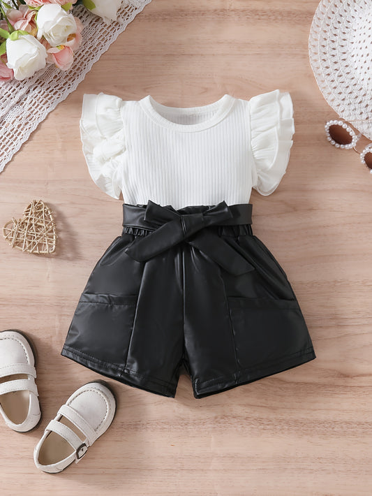 Ruffled sleeve top with round neckline and soft pocket shorts for outdoor wear.