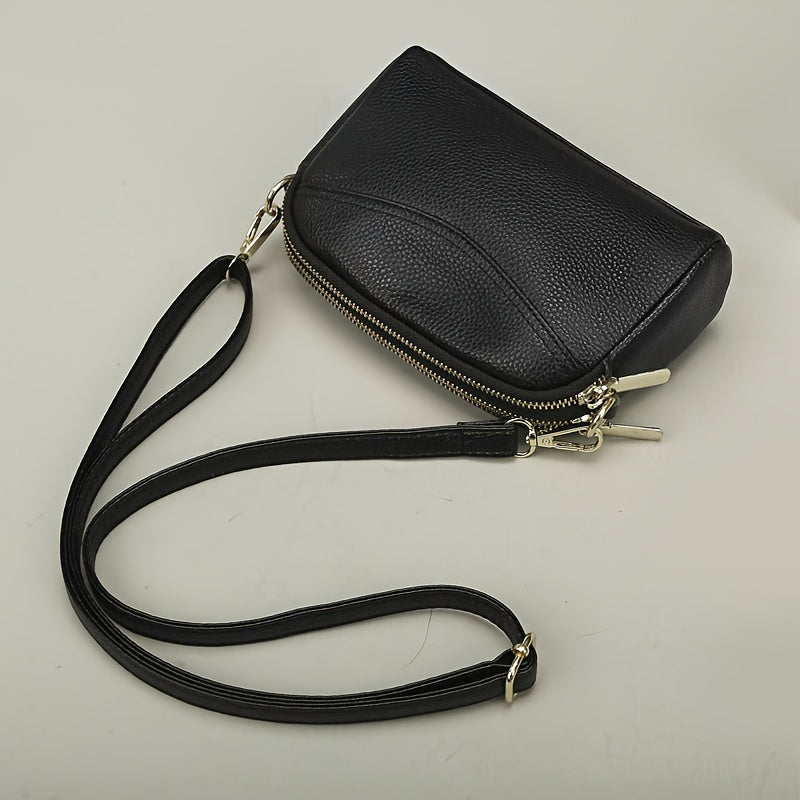 Women's genuine leather crossbody bag - solid color with adjustable strap, zipper closure, and polyester lining.