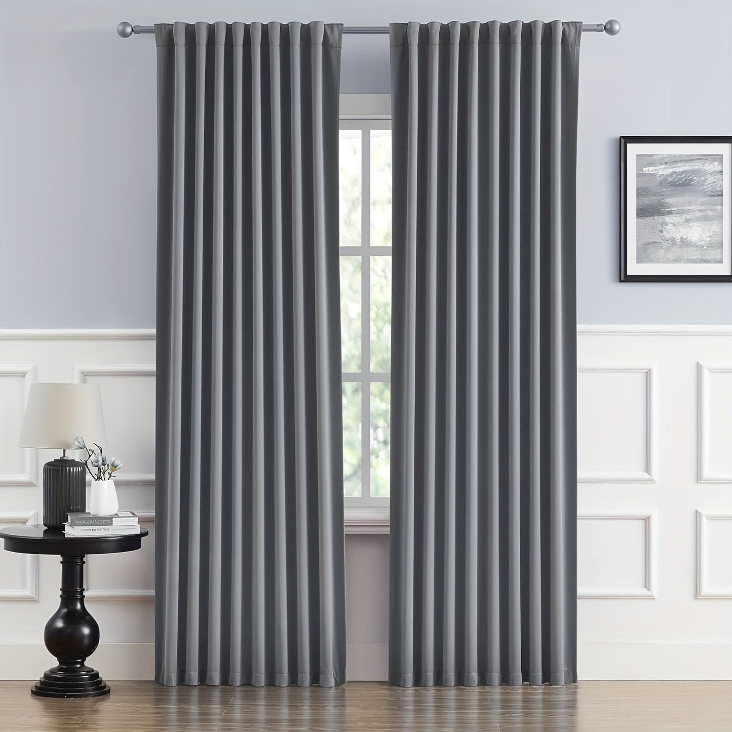 Cream and black thermal insulated blackout curtains with two panels. Perfect for darkening a room and providing insulation. Features back tab and rod pocket design for easy installation in a living room.