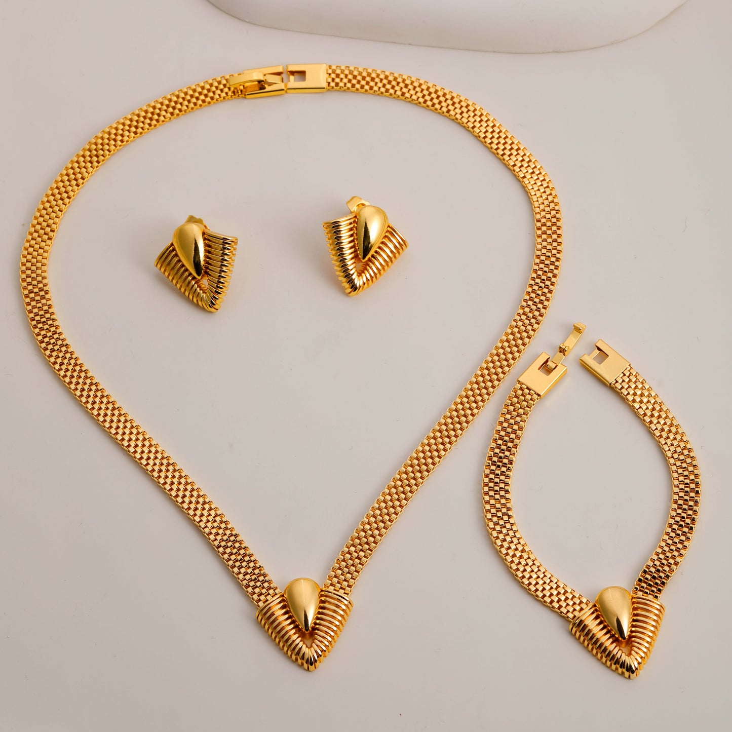 Set of 3 high-quality geometric V-shaped design jewelry pieces for women, including a necklace, bracelet, and earrings, all designed to accentuate the collarbone.