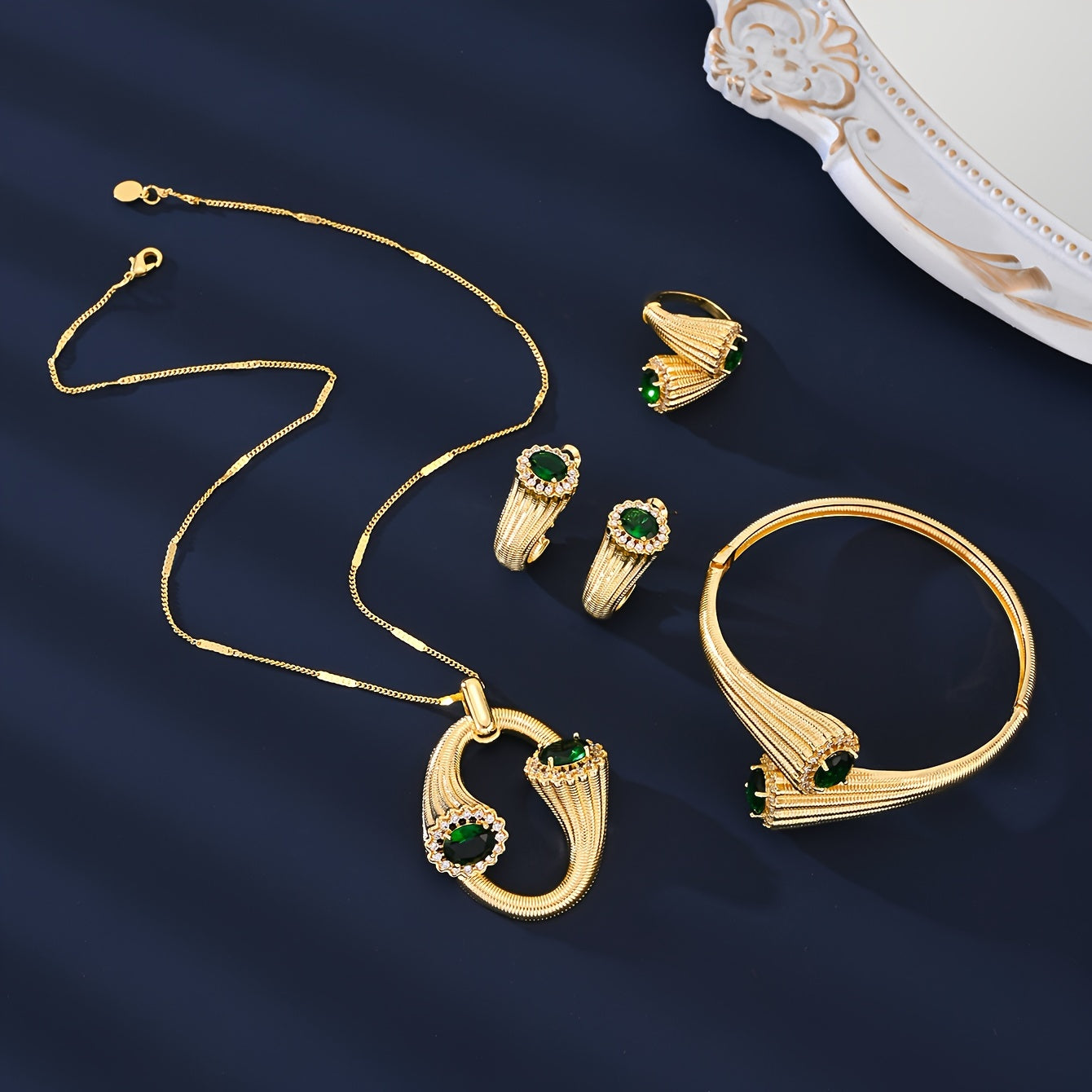 4-Piece Gold-Toned Copper Jewelry Set with zirconia Accents – Chic and stylish design perfect for any occasion. Makes the perfect Valentine's Day gift. Set includes a necklace, earrings, and two bangle-style ornamental pieces.