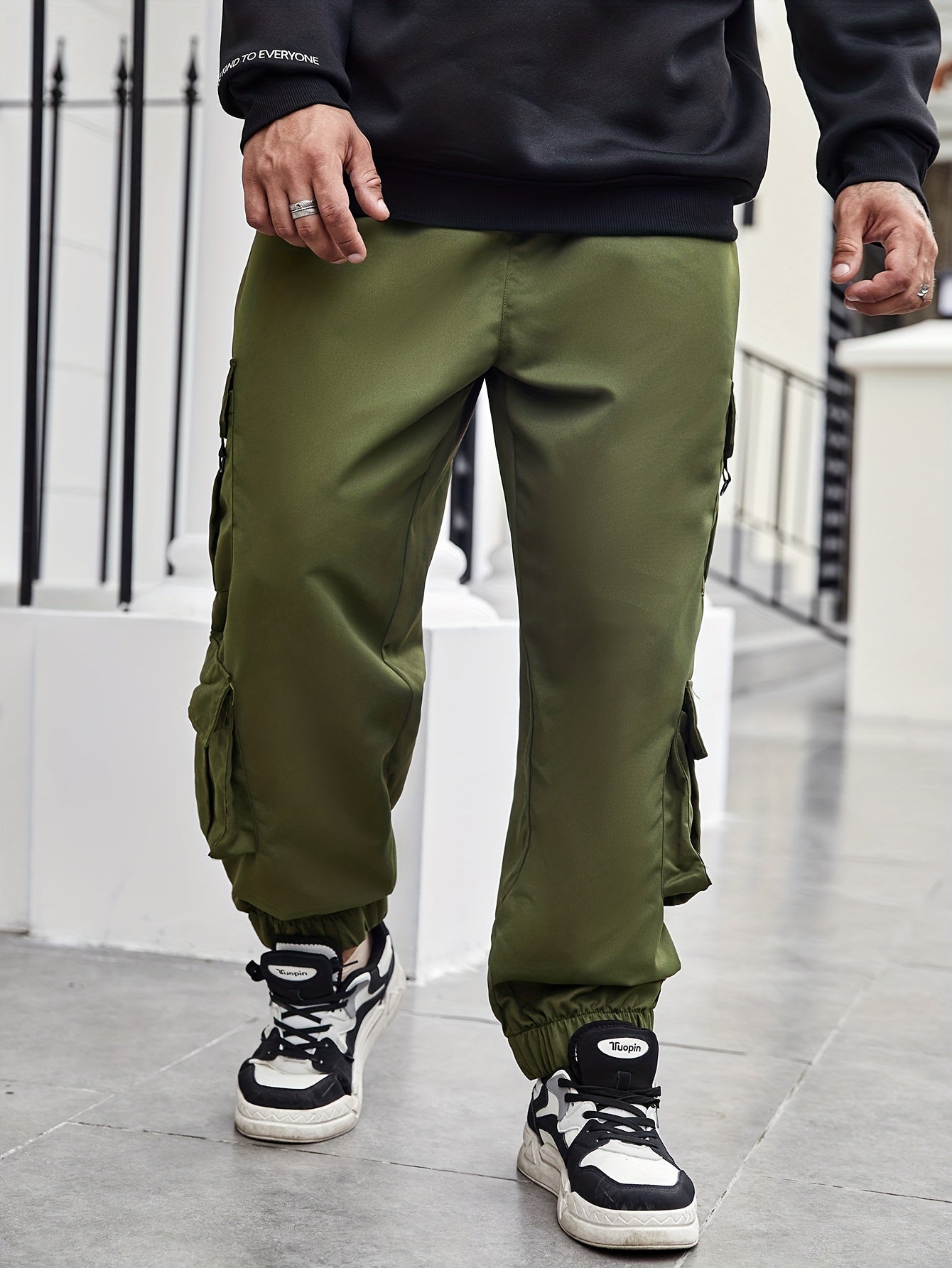 Men's plus size cargo pants with pockets for spring and fall fashion.