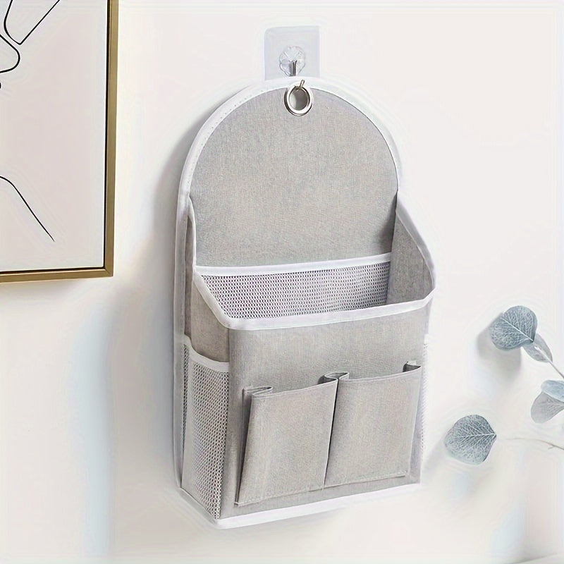 Wall-mounted storage organizer with dual pockets and mesh side compartment, ideal for dorms, wardrobes, homes, and offices. Comes in beige and grey, made of other materials.