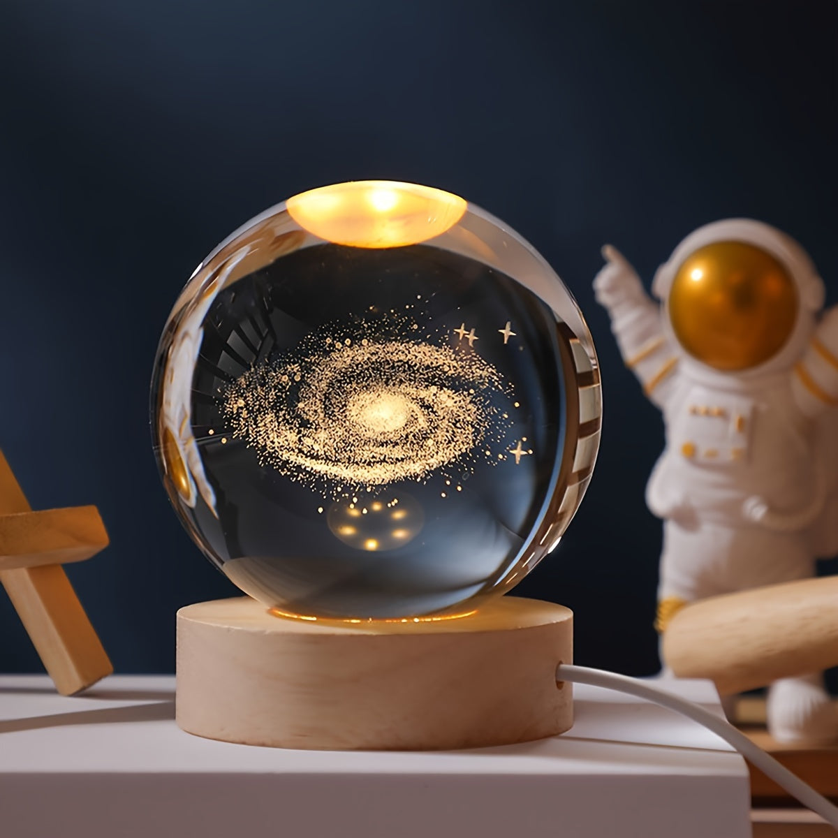 One 3D laser engraved crystal ball night light featuring the solar system and Saturn, powered by USB for home and office decoration, and makes a special gift for Valentine's Day, Christmas, or birthdays.