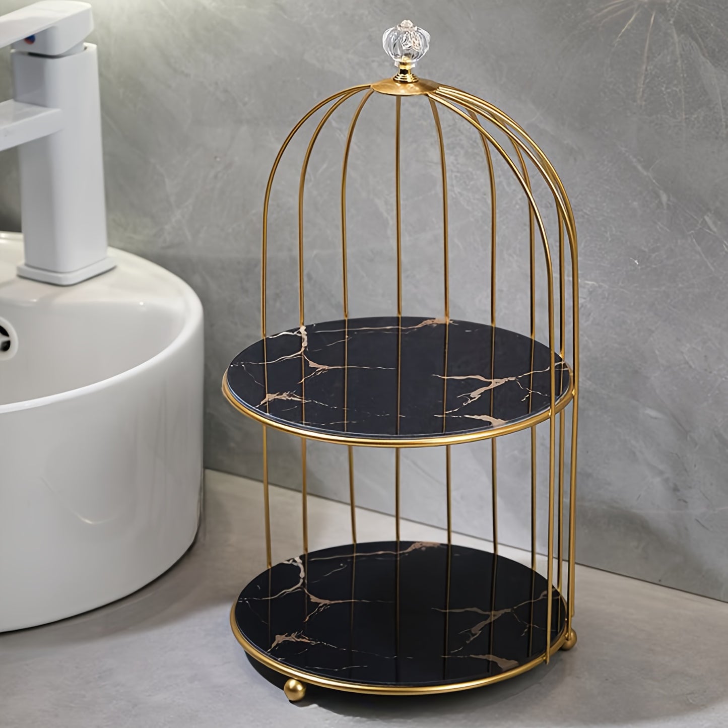 Elegant golden and white marble birdcage-inspired 2-tier makeup organizer with stainless steel rack and electrostatic spray finish. Portable and freestanding for bathroom and bedroom decor.