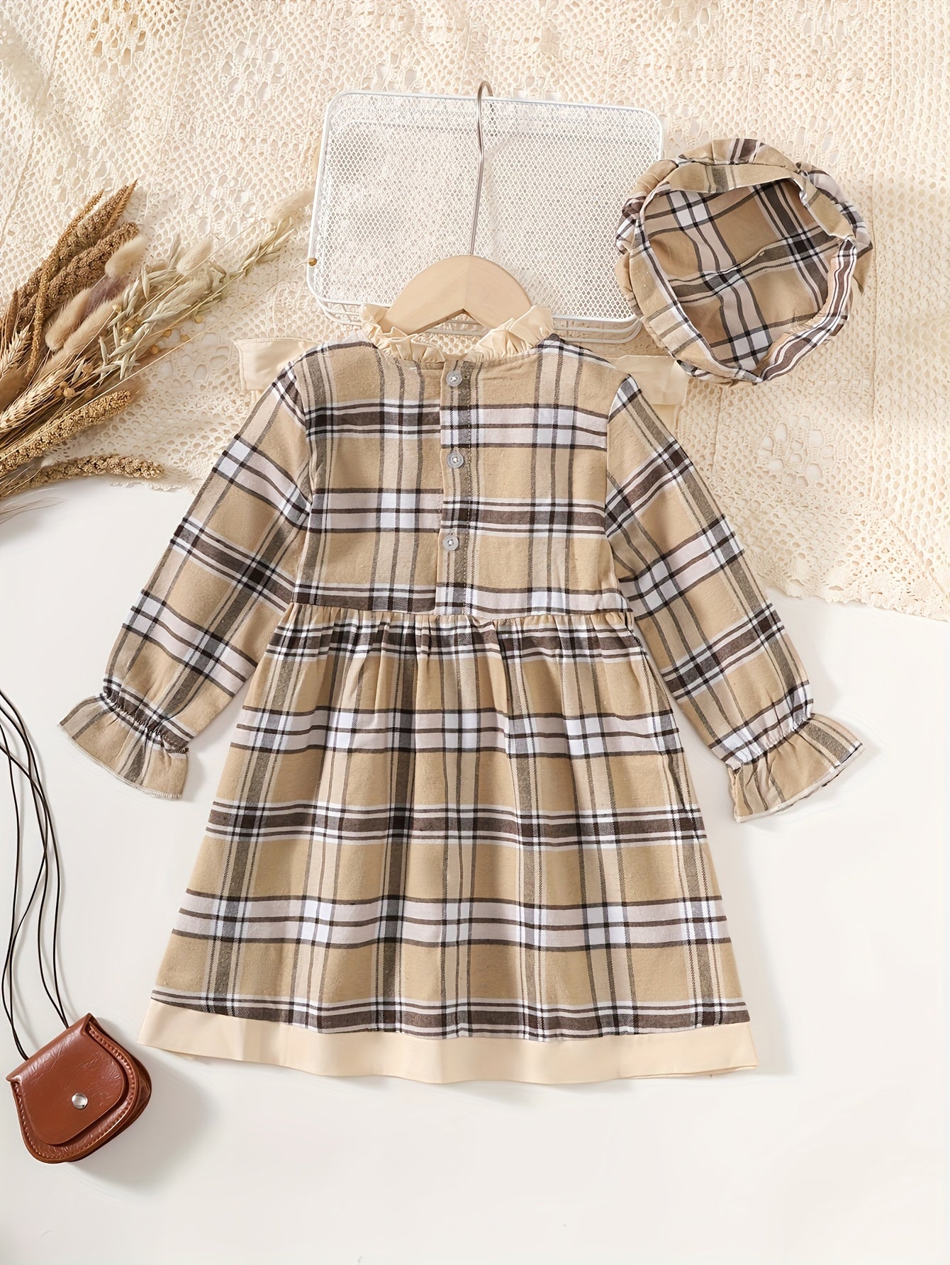 Stylish plaid dress with ruffle trim and matching hat, great for spring and fall. Machine washable.