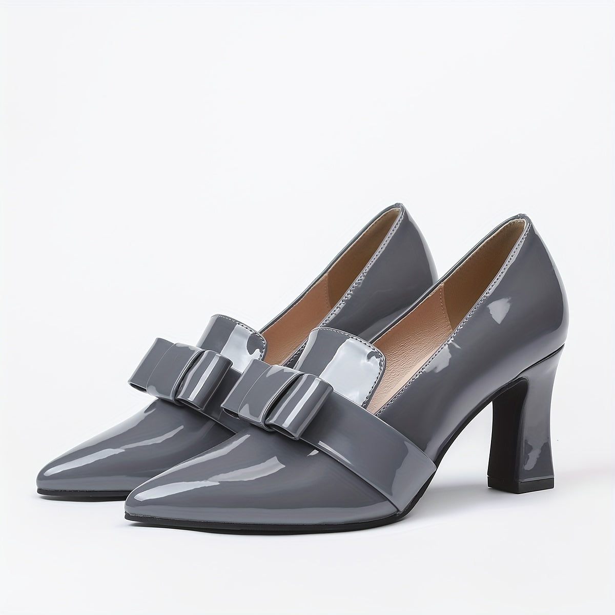 Women's elegant solid color pumps with bowknot design, block heel and waterproof features.