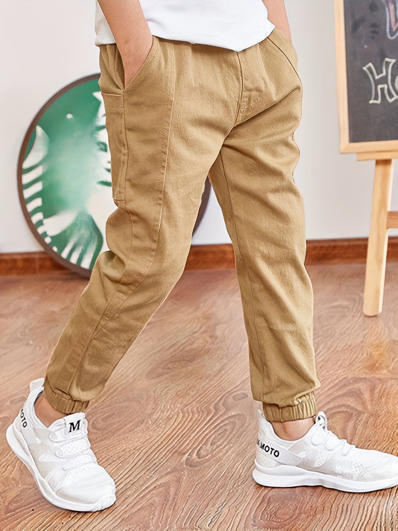 Boys' cotton cargo pants with elastic waist and pockets, ideal for casual and outdoor activities.