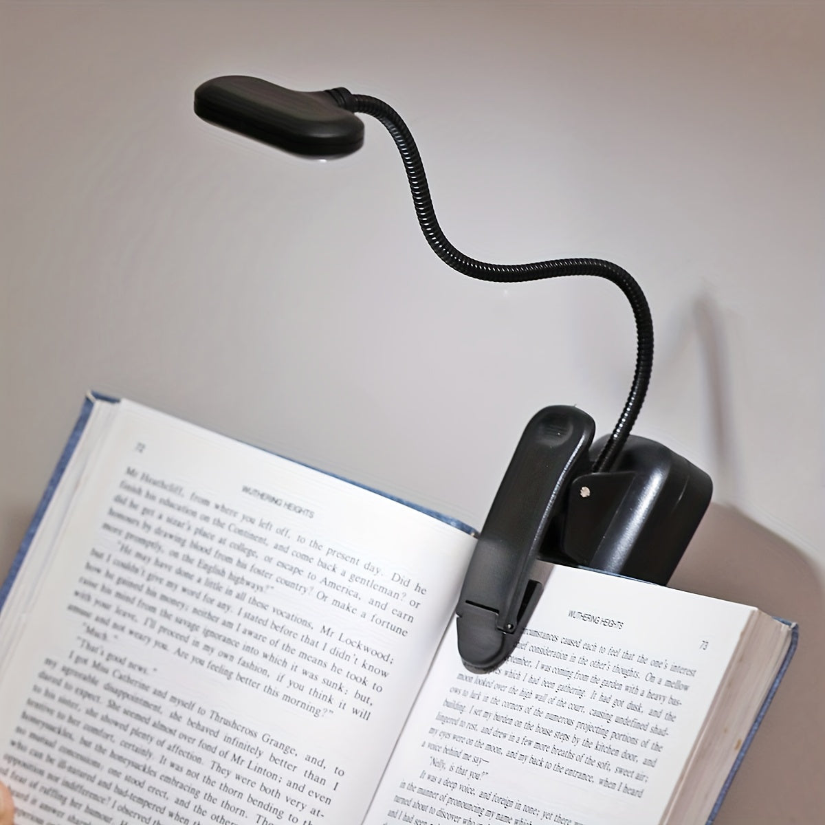 Portable battery-powered clip-on book light for reading that can also be used as a small table lamp or night light for room decor.