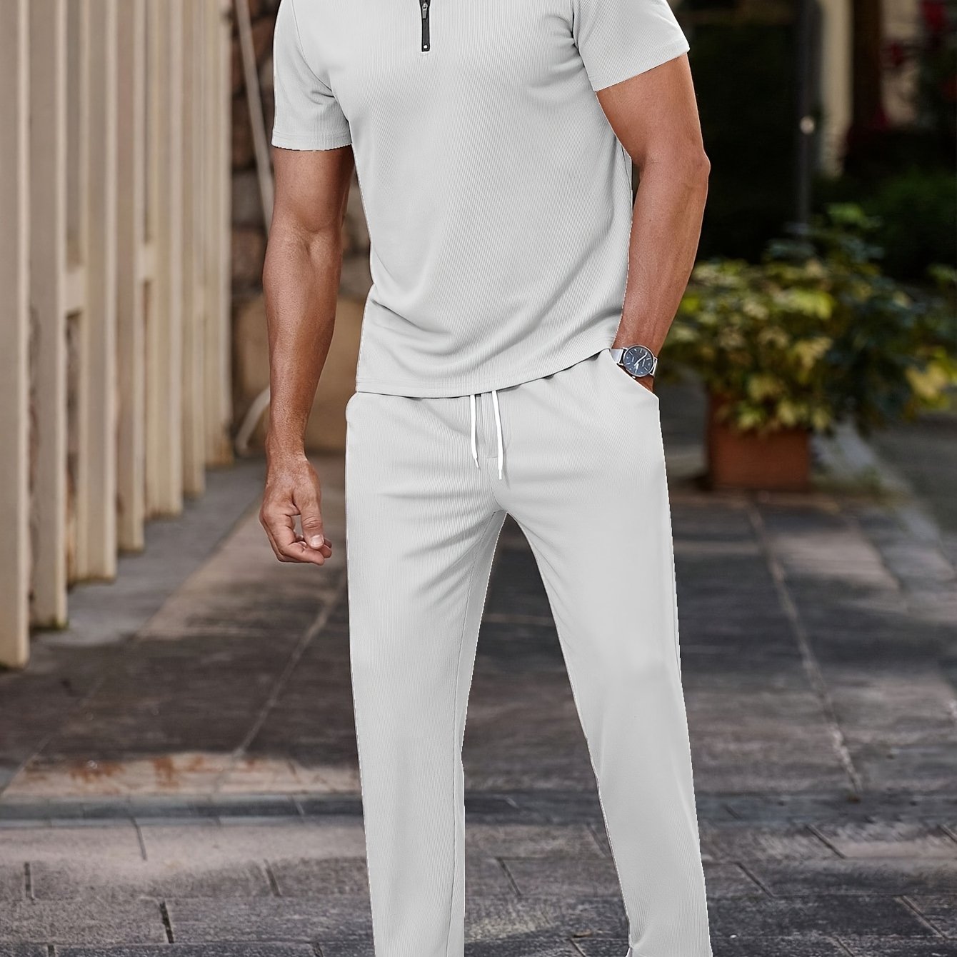 Men's casual outfit: half-zip short sleeve shirt and drawstring pants for outdoor activities.