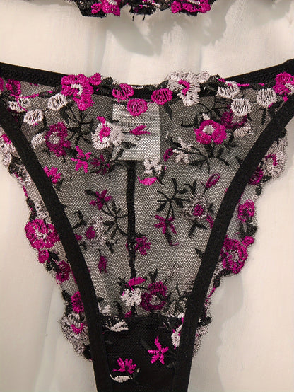 Stylish black lingerie set with floral embroidery, sheer mesh bra, low-rise thong, intricate back detailing, ideal for parties and everyday wear.