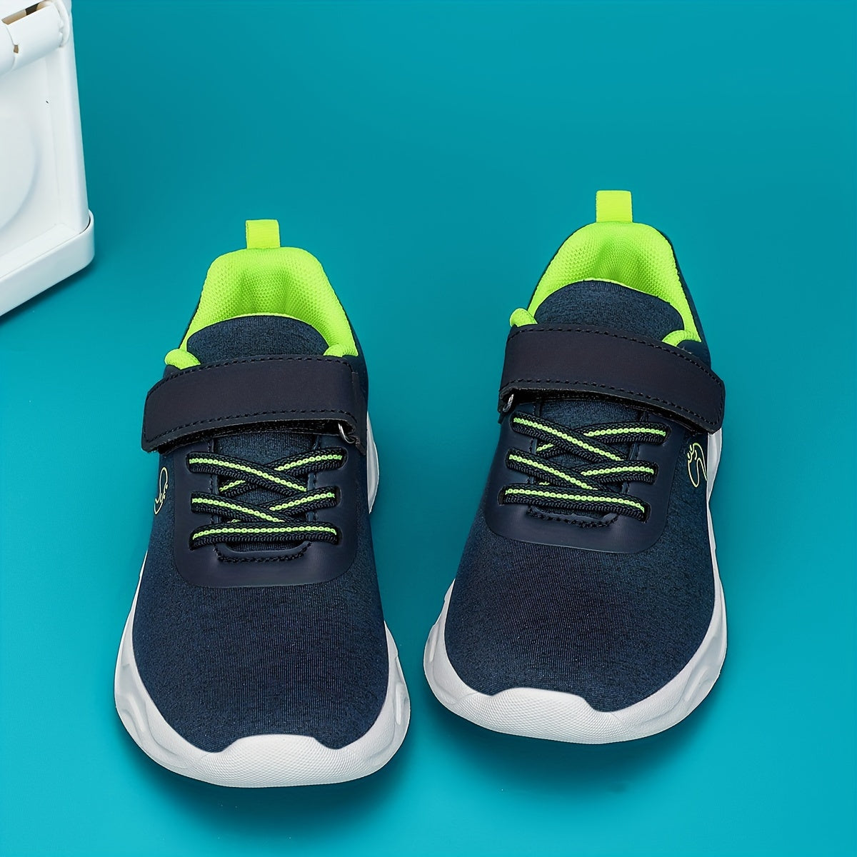 Breathable sneakers for kids with non-slip soles and hook and loop closure.