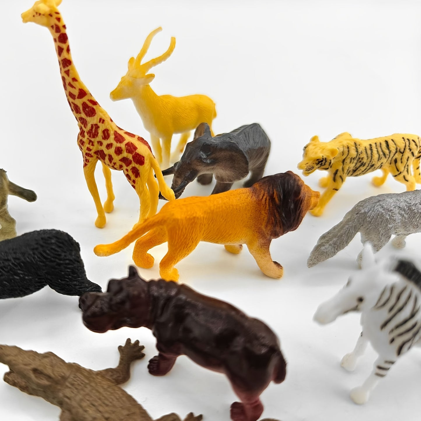 Wildlife Animal Figurines Set includes 12 pieces such as Lion, Tiger, Crocodile, Giraffe, Zebra, Elephant, and more. Suitable for ages 3+.